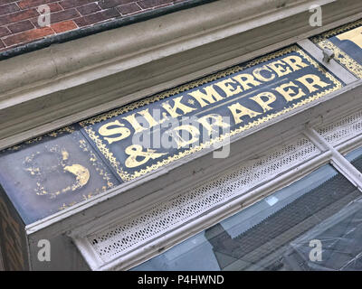 EH Hooper, Silk Mercer & Draper, Millinery & Mantles shop sign in gold lettering, 25 High Street, Bridgwater, Somerset, England, UK, TA6 3BE Stock Photo
