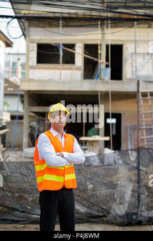 Handsome Persian man construction worker at the construction sit Stock Photo
