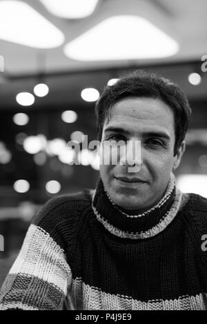 Handsome Persian man relaxing at the coffee shop in black and wh Stock Photo