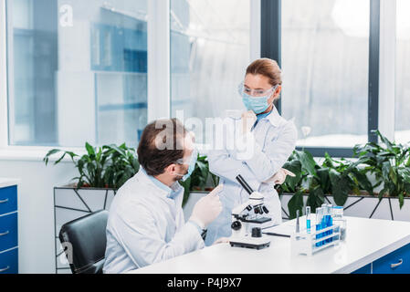 scientists having discussion at workplace in laboratory Stock Photo