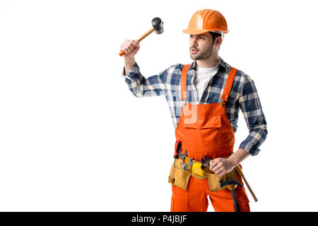 Bearded workman in orange overall and hardhat using hammer isolated on white Stock Photo