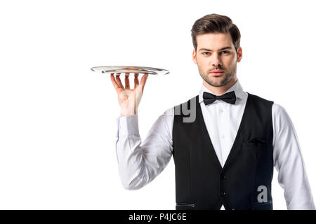 portrait of handsome waiter in suit vest with empty serving tray isolated on white Stock Photo