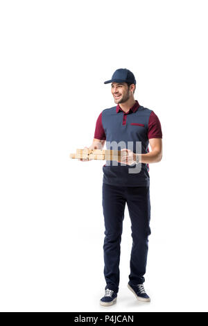 smiling delivery man with cardboard pizza boxes looking away isolated on white Stock Photo