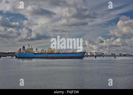 Panoramic image of a container ship passing cranes in Rotterdam harbor Stock Photo