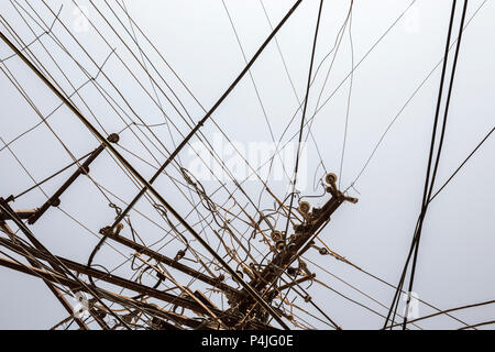 Messy electrical wires isolated on greyblue background Stock Photo