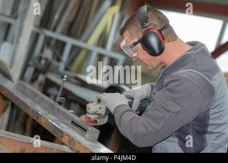 Worker using angle grinder Stock Photo