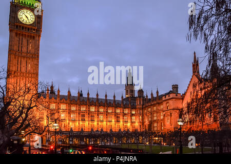View on the illuminated New Palace Yard of the Victorian Gothic Palace of Westminster with Elizabeth Tower (Big Ben) at night time in January. Stock Photo
