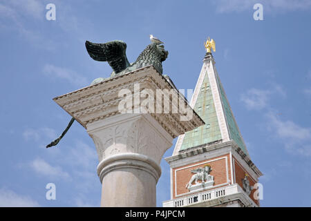 VENICE, ITALY - MAY 8, 2010: Two symbols of Venice: the Lion, the San Marco bell tower. Stock Photo