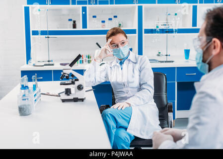 partial view of scientists having discussion at workplace in laboratory Stock Photo