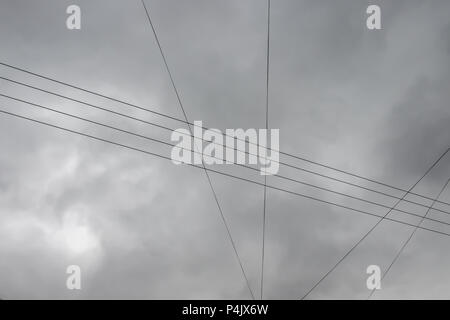 Electric Wires On Autumn Overcast Gray Cloud Sky Background. Abstract Template For Design With Copy Space. Stock Photo