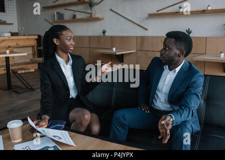 african american businesspeople discussing new business project in cafe Stock Photo