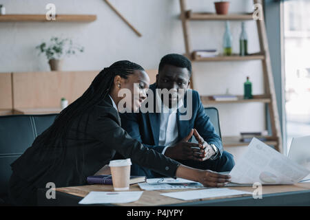 african american businesspeople discussing new business project in cafe Stock Photo