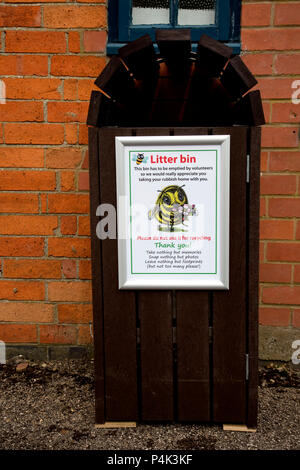 Litter bin with notice Three Bees community wildlife garden Mickleton UK Stock Photo