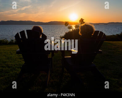 Mature couple enjoying the sunset over Lake Champlain. Stock Photo