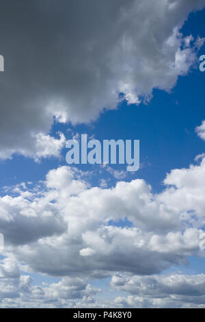 White and gray heap clouds in the blue sky. Sky and clouds over horizon. Stock Photo