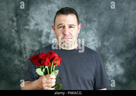 Sad lover or broken hearted man with roses concept Stock Photo