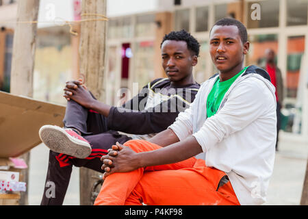 Addis Ababa, Ethiopia, January 27, 2014, Two young men relaxing on the street corner Stock Photo