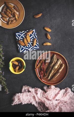 Camembert cheese with breadsticks and jam on old table with napkin Stock Photo