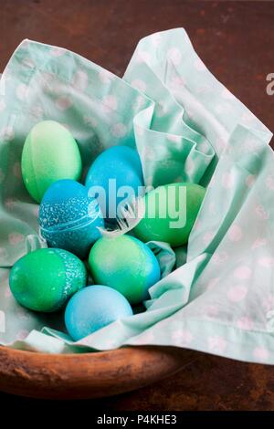 Dyed Easter eggs with batik patterns on a cloth in a basket Stock Photo