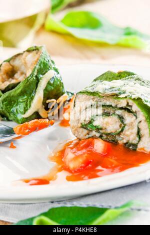 Rolled comfrey with freekeh filling and tomato sauce Stock Photo