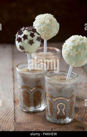 Cake pops with white chocolate icing and chocolate stars Stock Photo