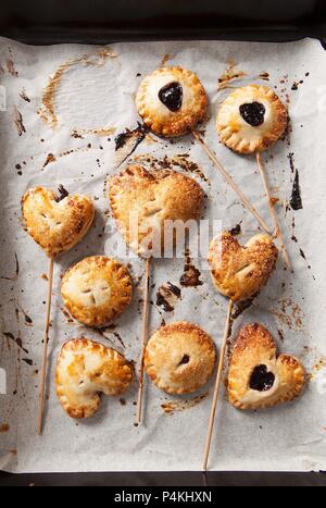 Cherry pie pops (small cherry pies on sticks) Stock Photo