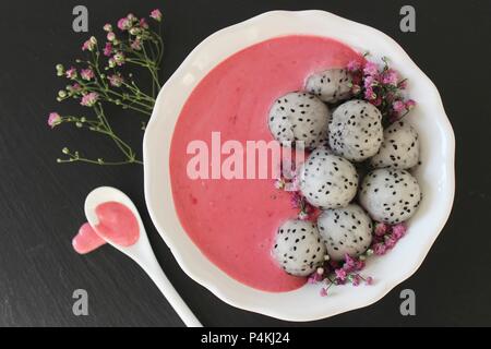 A pink smoothie bowl with dragon fruit balls Stock Photo