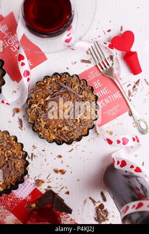 Valentine's Day dessert with red wine and decoration on a white table Stock Photo