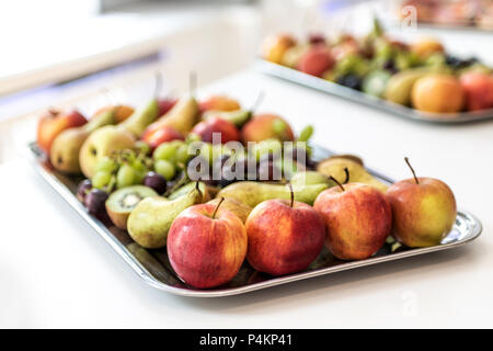 Plate with fresh tropical fruits on a white table of a buffet dinner Stock Photo