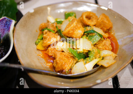 Stir fried squid with salted egg on brown disk Stock Photo