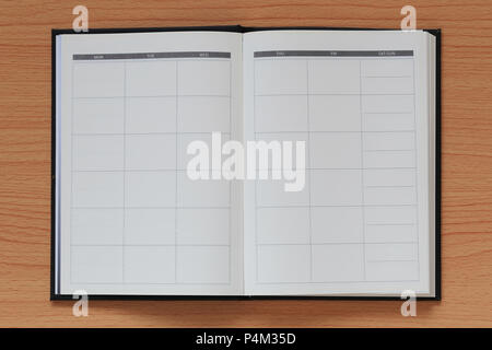 Empty book is placed on a brown wooden background and have copy space for design in your work concept. Stock Photo