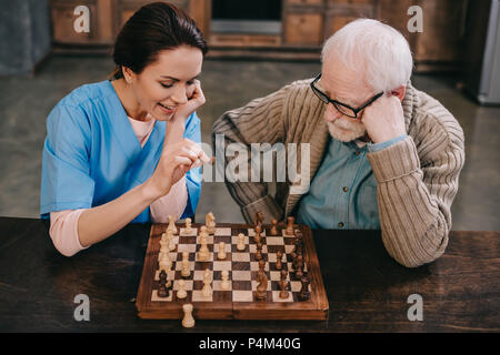 Top view of nurse and elder man playing chess Stock Photo