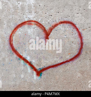 Texture of a concrete wall with a painted heart. Drawing a heart on a concrete wall can be used for postcards. Stock Photo