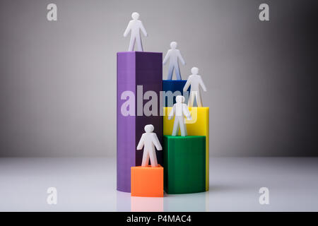 Human Figures Standing On 3D Pie Chart On White Background Stock Photo