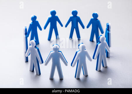 Close-up Of Human Figures Forming Circle Standing On White Background Stock Photo
