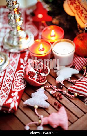 Pomegranate on a wooden table with Christmas decoration Stock Photo