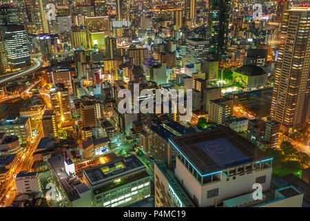 Osaka, Japan - April 28, 2017: aerial view of Osaka City Central Business downtown at night. Beautiful night scene of Osaka Skyline from Kita ward of Japan. Osaka nightscape details. Stock Photo