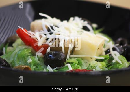 A mixed leaf salad with olives, peppers and cheese Stock Photo