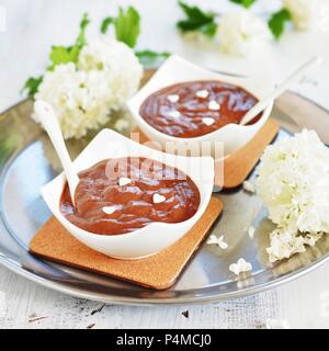 Two bowls of chocolate pudding with white sugar hearts Stock Photo