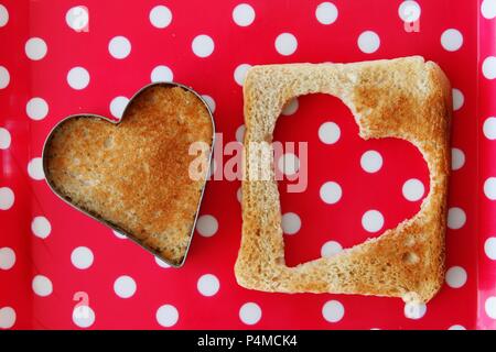 A heart cut out of a slice of toast Stock Photo