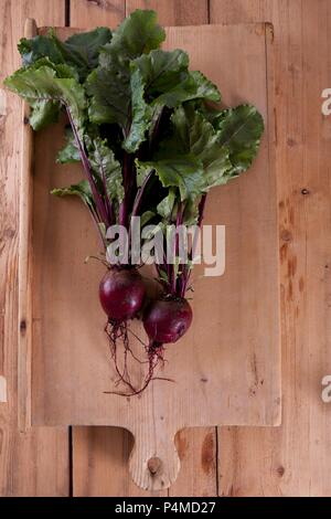 Beetroot with leaves on a wooden chopping board Stock Photo