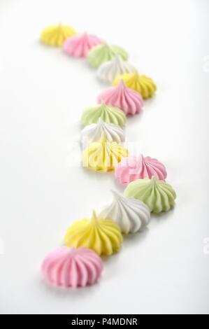 Colourful meringues on a white surface Stock Photo