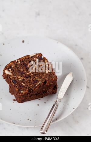 Two slices of banana bread with sunflower seeds, pumpkin seeds, cranberries, apple butter and walnut flour Stock Photo