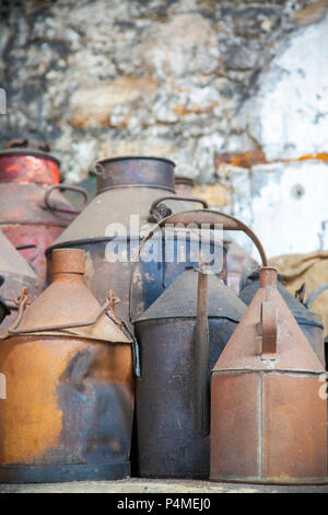 A group of rusty cans in an old workshop Stock Photo