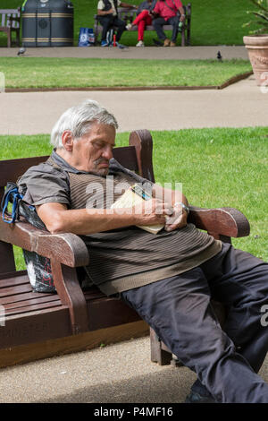 man falling asleep with a book Stock Photo