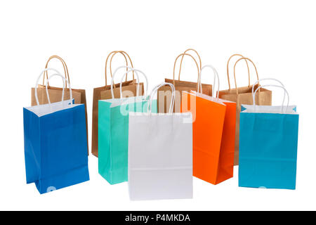 Variety of colored paper shopping bags on white background. Empty area. Stock Photo