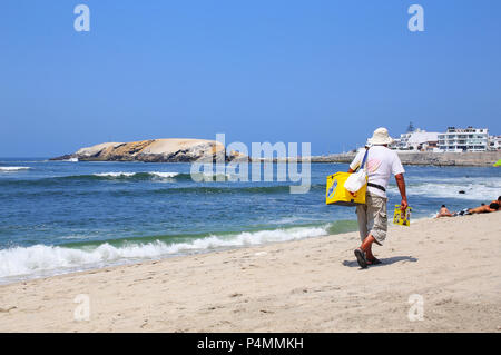 Local man selling ice cream at Punta Hermosa beach in Peru. Punta Hermosa is a popular beach town not far from Lima. Stock Photo