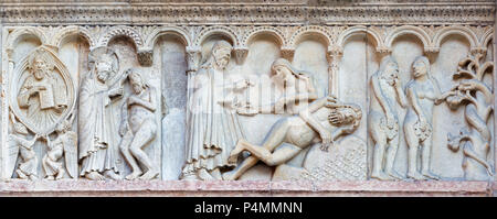 MODENA, ITALY - APRIL 14, 2018: The romanesque relief of creation of the man and woman on the facade of Duomo di Modena. Stock Photo