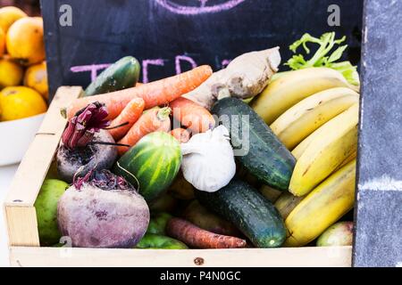 A wooden basket of different vegetables and fruits Stock Photo