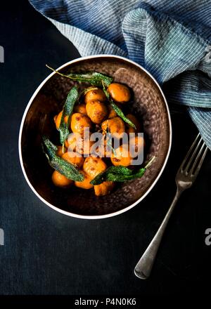 Homemade sweet potato gnocchi tossed in a sage and garlic butter Stock Photo